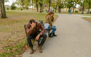 Couple sitting on a bench having a fight