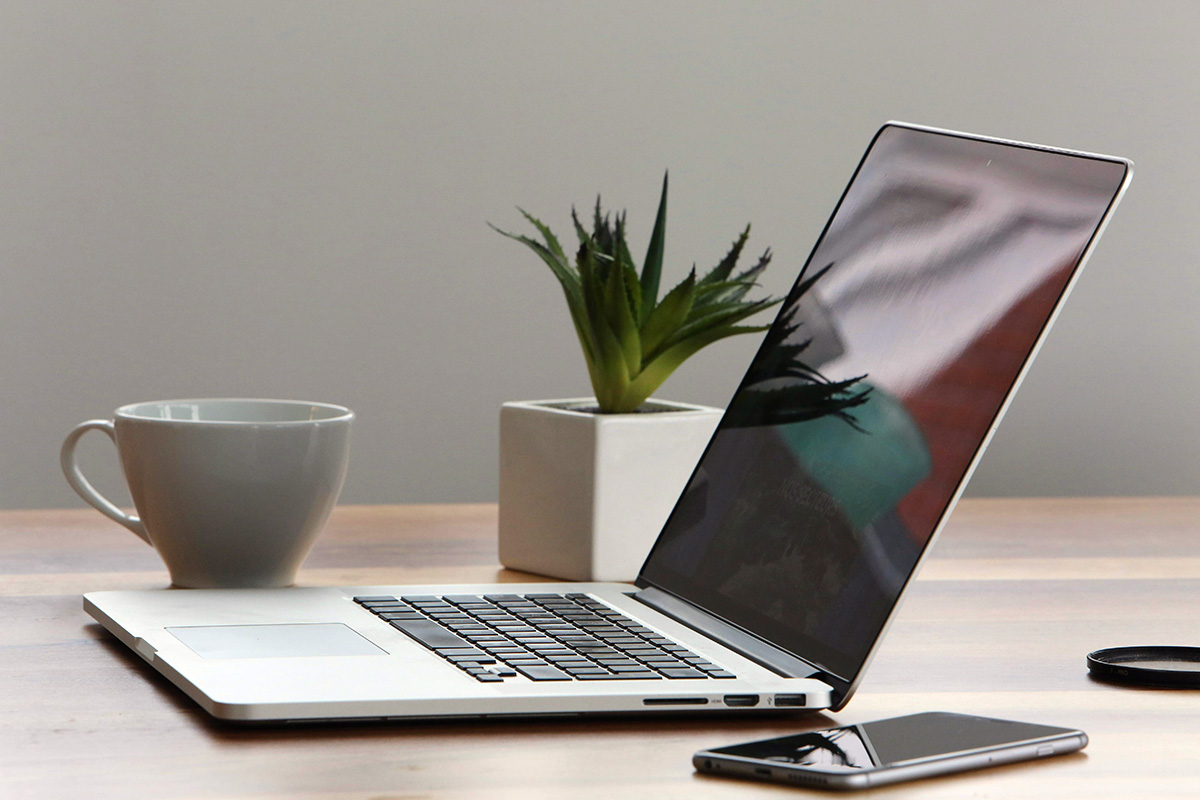 Laptop and mug of tea on a table